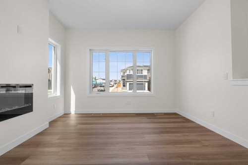 568 Buffaloberry Manor Se, Calgary, AB - Indoor Photo Showing Other Room With Fireplace