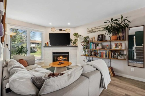109 Coachway Lane Sw, Calgary, AB - Indoor Photo Showing Living Room With Fireplace