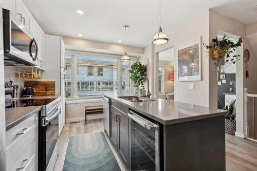 109 Coachway Lane Sw, Calgary, AB - Indoor Photo Showing Kitchen With Stainless Steel Kitchen With Double Sink With Upgraded Kitchen