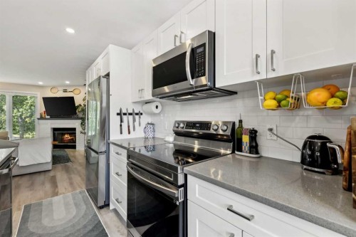 109 Coachway Lane Sw, Calgary, AB - Indoor Photo Showing Kitchen With Double Sink With Upgraded Kitchen