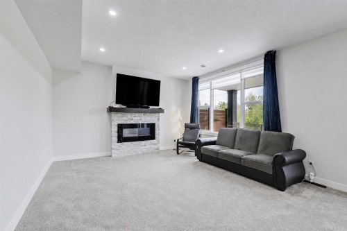 548 Cranbrook Gardens Se, Calgary, AB - Indoor Photo Showing Living Room With Fireplace