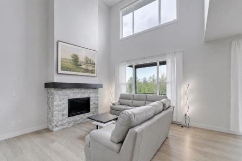 548 Cranbrook Gardens Se, Calgary, AB - Indoor Photo Showing Living Room With Fireplace