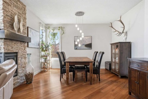 135 Cranleigh View Se, Calgary, AB - Indoor Photo Showing Dining Room With Fireplace