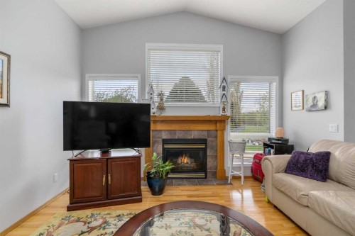 310 Riverside Garden Nw, High River, AB - Indoor Photo Showing Living Room With Fireplace