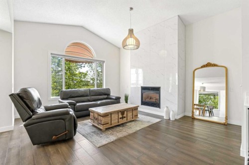 147 Hamptons Heath Nw, Calgary, AB - Indoor Photo Showing Living Room With Fireplace
