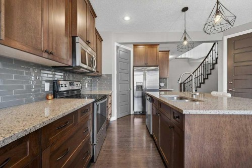 76 Rainbow Falls Boulevard, Chestermere, AB - Indoor Photo Showing Kitchen With Double Sink With Upgraded Kitchen