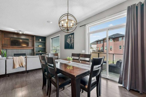 76 Rainbow Falls Boulevard, Chestermere, AB - Indoor Photo Showing Dining Room With Fireplace