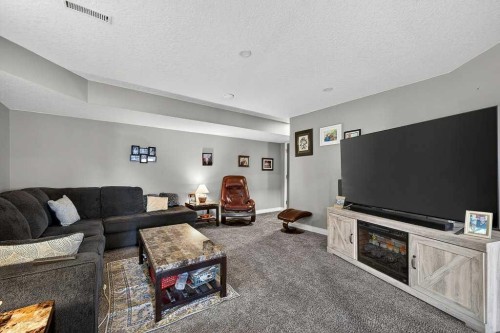 76 Rainbow Falls Boulevard, Chestermere, AB - Indoor Photo Showing Living Room