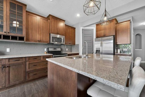76 Rainbow Falls Boulevard, Chestermere, AB - Indoor Photo Showing Kitchen With Double Sink