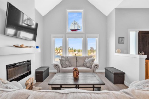 1098 Creekside Boulevard Sw, Calgary, AB - Indoor Photo Showing Living Room With Fireplace