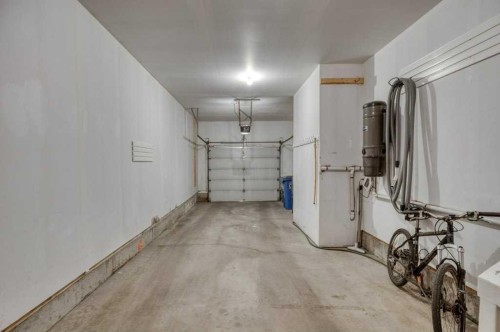 31-8 Riverview Circle, Cochrane, AB - Indoor Photo Showing Garage