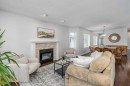 31-8 Riverview Circle, Cochrane, AB  - Indoor Photo Showing Living Room With Fireplace 