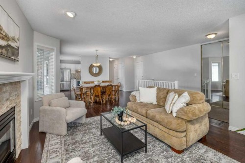31-8 Riverview Circle, Cochrane, AB - Indoor Photo Showing Living Room With Fireplace
