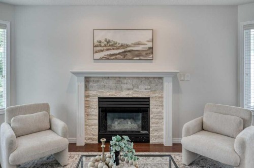 31-8 Riverview Circle, Cochrane, AB - Indoor Photo Showing Living Room With Fireplace