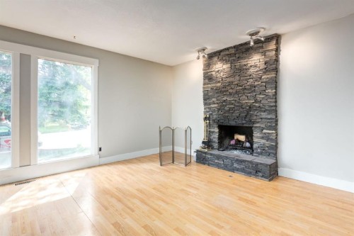3 Berwick Close Nw, Calgary, AB - Indoor Photo Showing Living Room With Fireplace