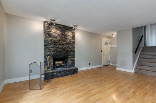 3 Berwick Close Nw, Calgary, AB - Indoor Photo Showing Living Room With Fireplace