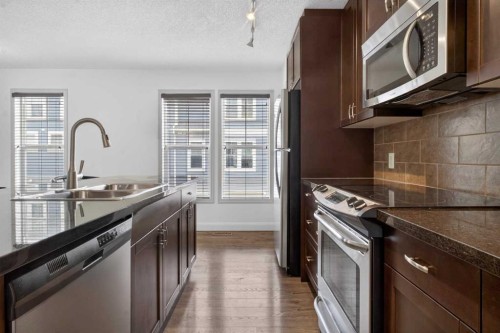 128 Auburn Bay Common Se, Calgary, AB - Indoor Photo Showing Kitchen With Stainless Steel Kitchen With Double Sink With Upgraded Kitchen