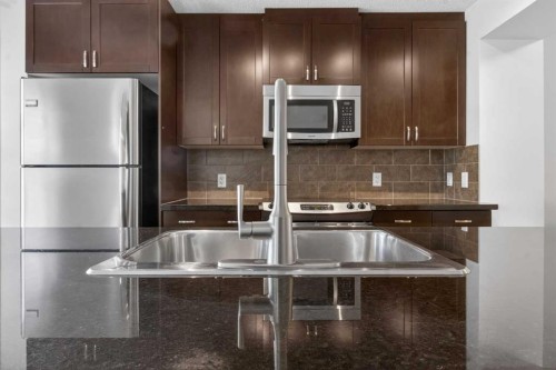 128 Auburn Bay Common Se, Calgary, AB - Indoor Photo Showing Kitchen With Stainless Steel Kitchen With Double Sink With Upgraded Kitchen