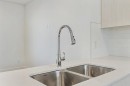 124-1862 Cornerstone Boulevard Ne, Calgary, AB  - Indoor Photo Showing Kitchen With Double Sink 