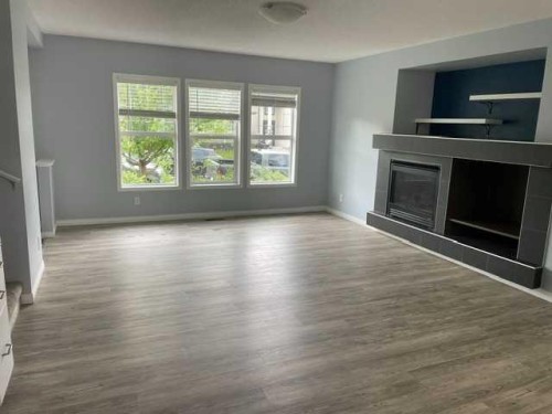 681 Evermeadow Road Sw, Calgary, AB - Indoor Photo Showing Living Room With Fireplace