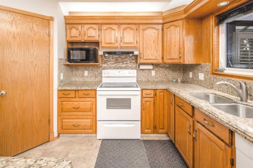 37 Arbour Summit Close Nw, Calgary, AB - Indoor Photo Showing Kitchen With Double Sink