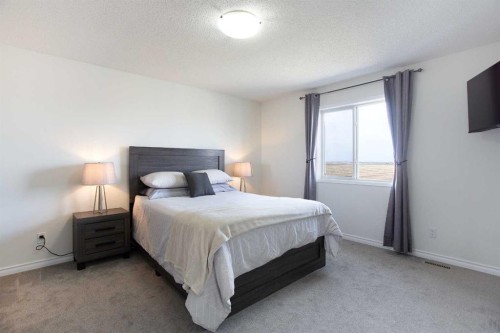 514 Stonegate Road Nw, Airdrie, AB - Indoor Photo Showing Bedroom