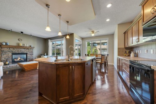 32 Everoak Close Sw, Calgary, AB - Indoor Photo Showing Kitchen With Fireplace