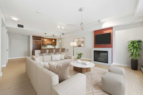103-733 2 Avenue Sw, Calgary, AB - Indoor Photo Showing Living Room With Fireplace