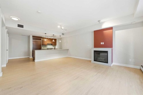 103-733 2 Avenue Sw, Calgary, AB - Indoor Photo Showing Living Room With Fireplace