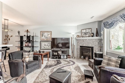 51 Cedar Springs Gardens Sw, Calgary, AB - Indoor Photo Showing Living Room With Fireplace
