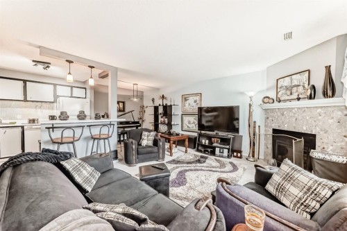 51 Cedar Springs Gardens Sw, Calgary, AB - Indoor Photo Showing Living Room With Fireplace