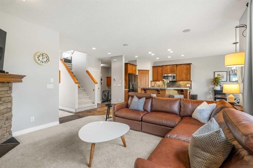 194 Brightonstone Bay Se, Calgary, AB - Indoor Photo Showing Living Room With Fireplace