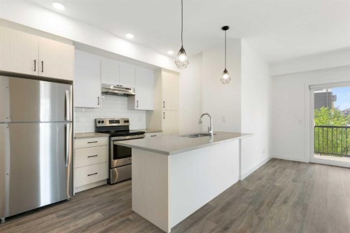 401-24 Rivercrest Drive, Cochrane, AB - Indoor Photo Showing Kitchen With Upgraded Kitchen