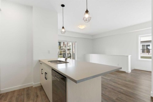 401-24 Rivercrest Drive, Cochrane, AB - Indoor Photo Showing Kitchen With Double Sink