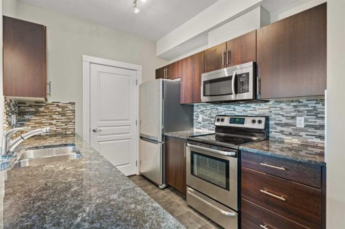 408-2300 Evanston Square Nw, Calgary, AB - Indoor Photo Showing Kitchen With Stainless Steel Kitchen With Double Sink