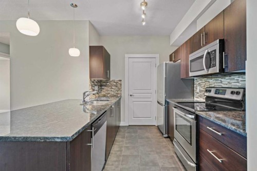 408-2300 Evanston Square Nw, Calgary, AB - Indoor Photo Showing Kitchen With Stainless Steel Kitchen With Upgraded Kitchen
