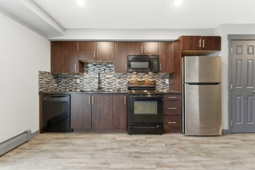 1204-755 Copperpond Boulevard Se, Calgary, AB - Indoor Photo Showing Kitchen With Stainless Steel Kitchen With Upgraded Kitchen