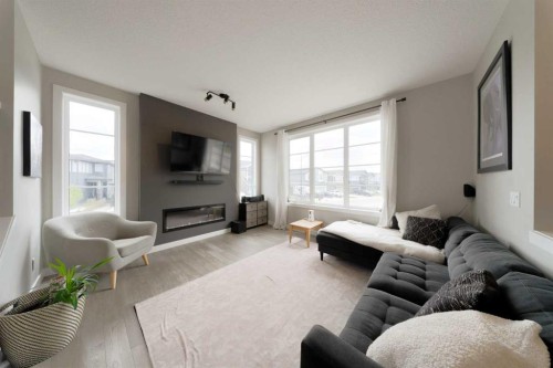 41 Precedence Glen, Cochrane, AB - Indoor Photo Showing Living Room With Fireplace