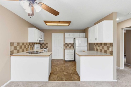 307-105 7 Avenue Se, High River, AB - Indoor Photo Showing Kitchen With Double Sink