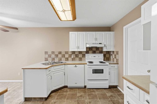 307-105 7 Avenue Se, High River, AB - Indoor Photo Showing Kitchen With Double Sink