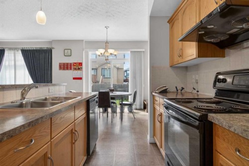 156 Saddlecrest Park Ne, Calgary, AB - Indoor Photo Showing Kitchen With Double Sink