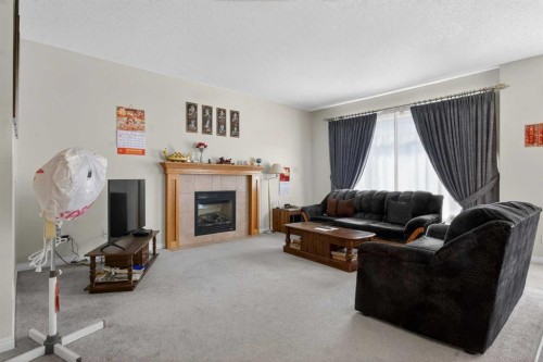 156 Saddlecrest Park Ne, Calgary, AB - Indoor Photo Showing Living Room With Fireplace