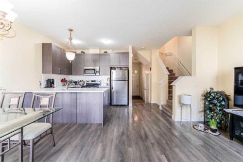 1402 Jumping Pound Common, Cochrane, AB - Indoor Photo Showing Kitchen With Stainless Steel Kitchen