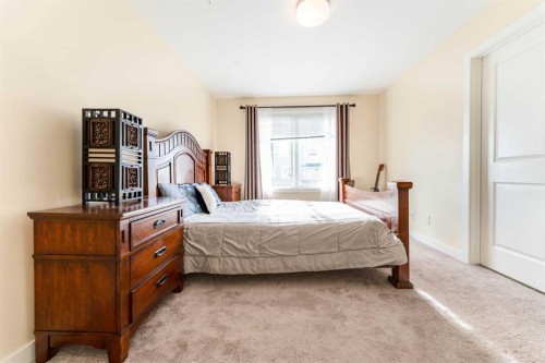 1402 Jumping Pound Common, Cochrane, AB - Indoor Photo Showing Bedroom