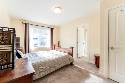 1402 Jumping Pound Common, Cochrane, AB - Indoor Photo Showing Bedroom