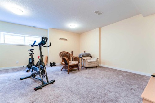 1402 Jumping Pound Common, Cochrane, AB - Indoor Photo Showing Gym Room