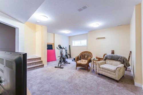 1402 Jumping Pound Common, Cochrane, AB - Indoor Photo Showing Gym Room