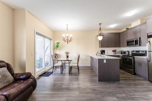 1402 Jumping Pound Common, Cochrane, AB - Indoor Photo Showing Kitchen With Stainless Steel Kitchen