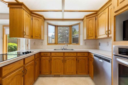 23 Millside Place Sw, Calgary, AB - Indoor Photo Showing Kitchen With Double Sink
