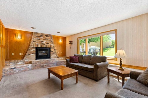 23 Millside Place Sw, Calgary, AB - Indoor Photo Showing Living Room With Fireplace